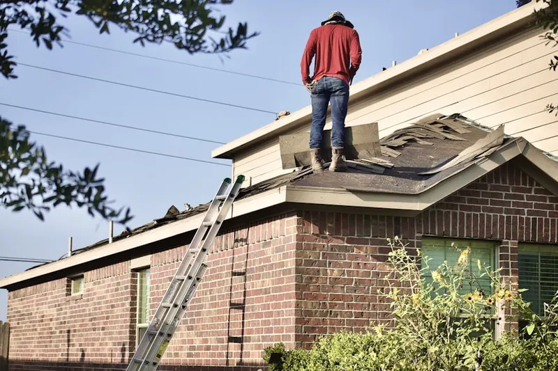 Professional roofer working on a residential roof in Augerville